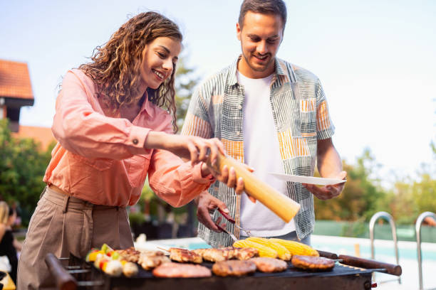 istock Young Caucasian couple making barbecue 1682612737