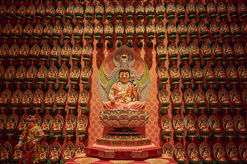 The large Buddha statue at the Buddha Tooth Relic Temple in Singapore, surrounded by smaller statues