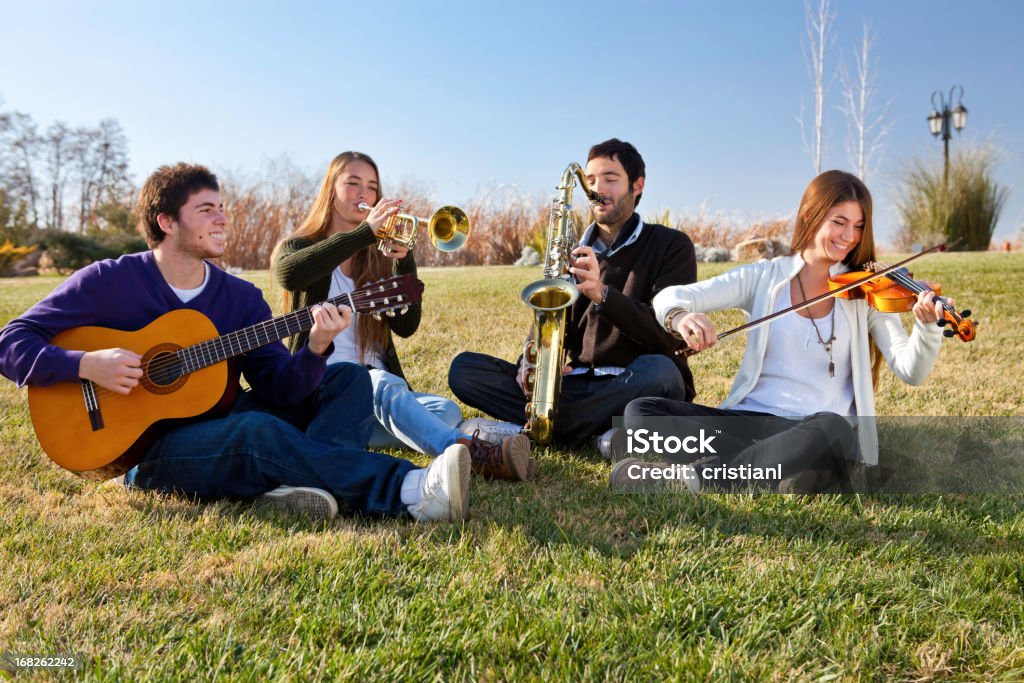 Teamwork Young music band playing guitar, trumpet, saxophone and violin Orchestra Stock Photo