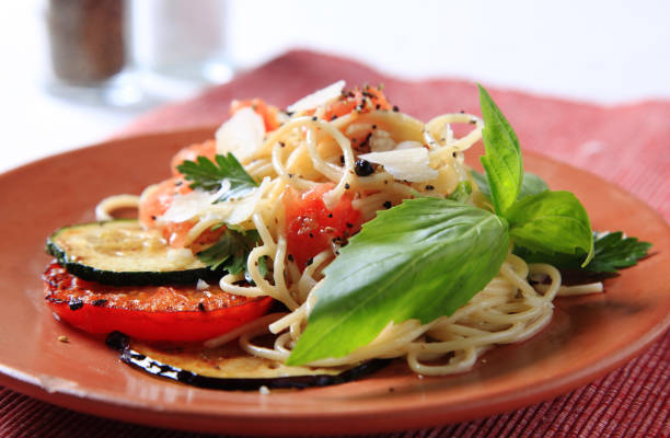 Spaghetti with baked tomato, zucchini and aubergine