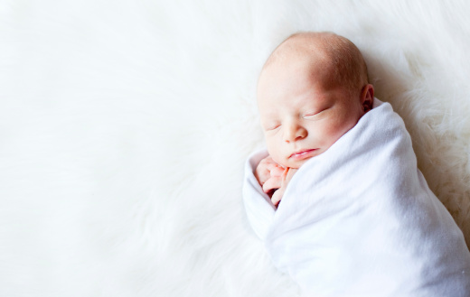 Color image of a newborn baby  on a white background.http://www.littlebitoflifephotography.com/istock/schoolkids.jpg