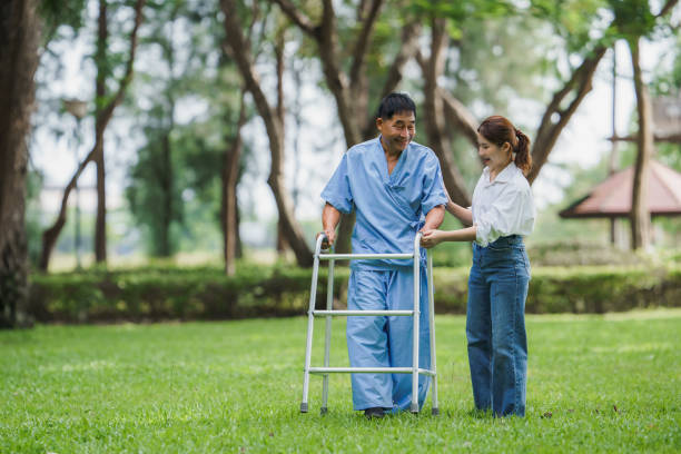 istock Physical therapy, knee, caring for the elderly, daughter helping father with physical therapy, learning to walk in garden, physical therapist helping an elderly patient do physical therapy in garden 1682623197