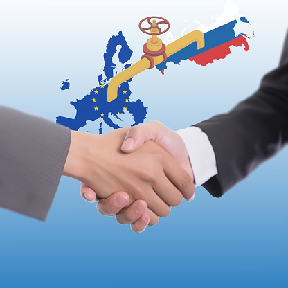 Handshake of diplomatic agreements and a peaceful. Fuel gas pipeline and valve transportation of Russia and European Union country.