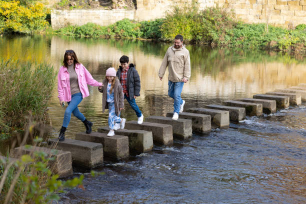 istock Crossing Stepping Stones Together 1682625853