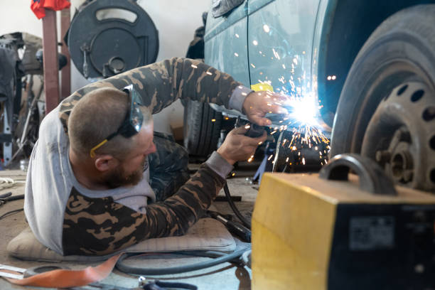 istock The mechanic welds a new threshold to a car. 1682630275