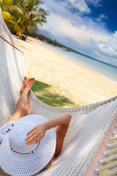 istock Young woman relaxing in a hammock. 168263302
