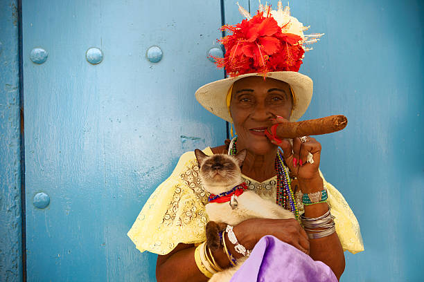 Cigar Cuban woman smoking a large Cigar - added grain cuban ethnicity stock pictures, royalty-free photos & images