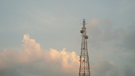 Telecommunication tower and the beautiful colors of sunset sky background