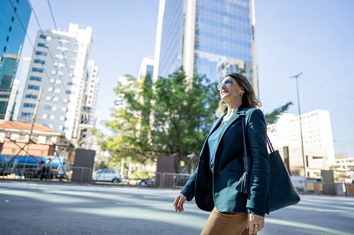Mature businesswoman walking outdoors