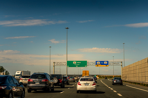 Toronto, Canada - August 31, 2022: Some cars on a multilane highway to toronto in canada.