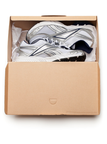 New sports shoes in a shoe box, isolated on white.