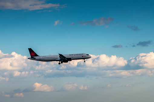 Toronto, Canada - August 31, 2022: Air Canada airplane flying over Toronto in Canada