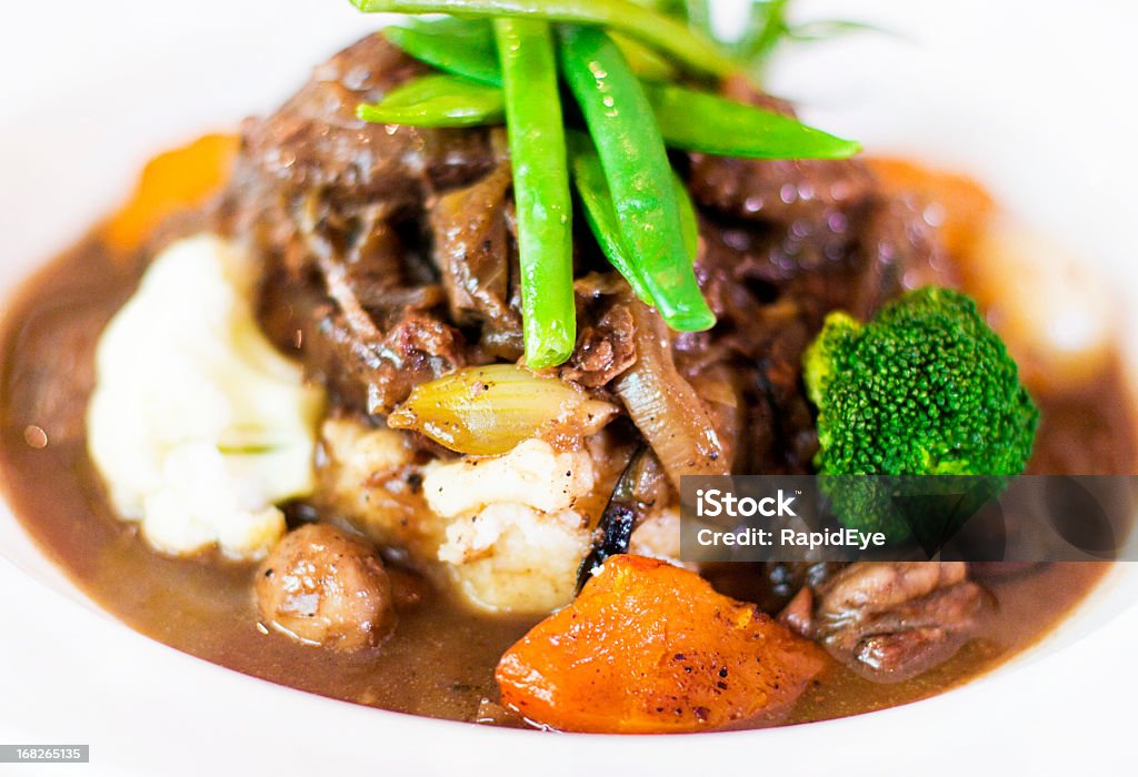Delicious looking plate of beef stew with vegetables A plate of beef stew with green beans, broccoli, squash, onion and mashed potato. Beef Stew Stock Photo