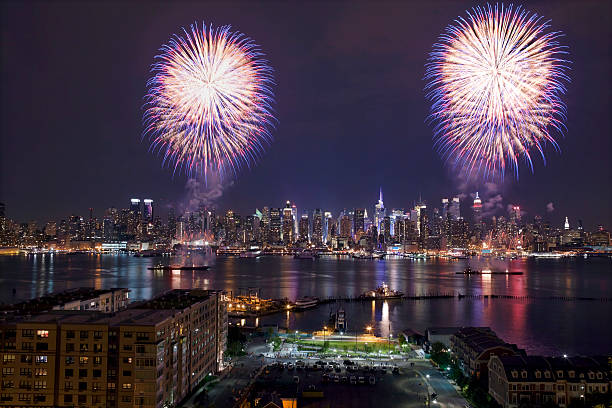 New York City Syncronized Fireworks July 4th on the Hudson River in front of Manhattan new years eve new york stock pictures, royalty-free photos & images