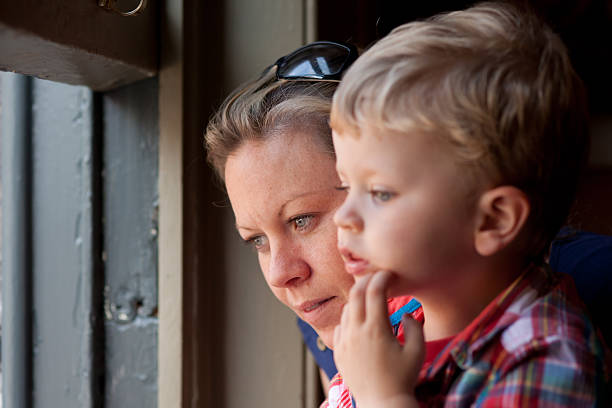 istock Mother and son sitting at a window 168265448