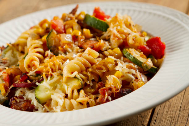 Penne pasta baked with zucchini, onion, corn, chopped tomato, crispy bacon and mozzarella cheese.