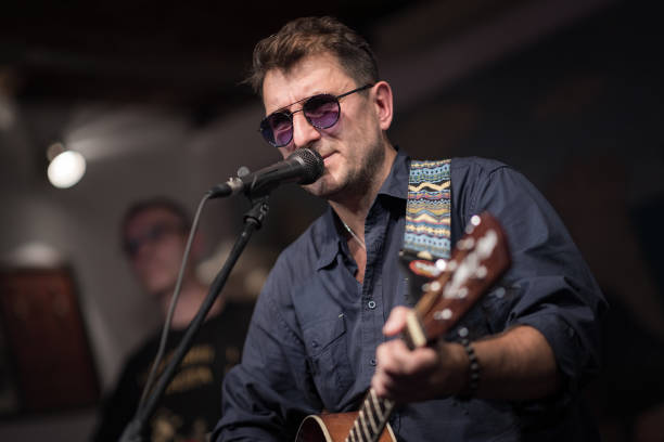 istock Band performs on stage, rock music concert. 1682668974