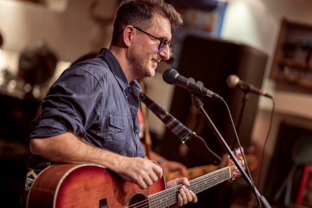 istock Band performs on stage, rock music concert. 1682669015