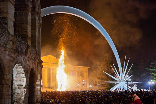 People in Piazza Bra is attending the final act of the celebrations of Christmas in Verona. The large puppet in front of City Hall, just steps from the Arena, is burning and the fire reaches almost 10 meters in high.Traditionally, when Christmas time is running out, large bonfires are made in Verona and in all his district to remember the ancient propitiatory rites to wish a happy New Year. 