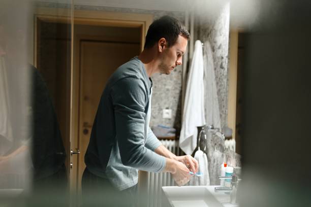 istock Man brushing his teeth in the bathroom 1682669596