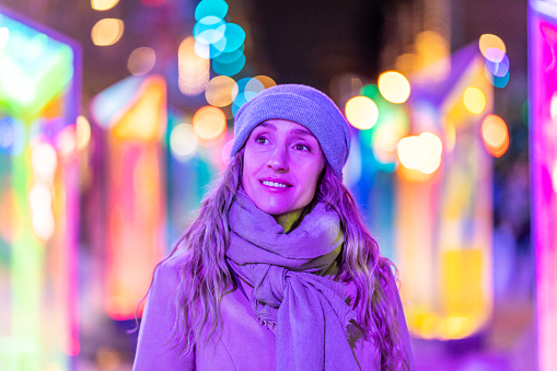 A Portuguese woman enjoying the Montreal Christmas market at night.
