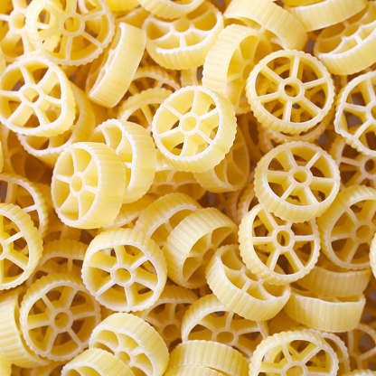 Wheel shaped pasta on weight scale\u2028http://www.massimomerlini.it/is/food.jpg\u2028http://www.massimomerlini.it/is/stilllife.jpg