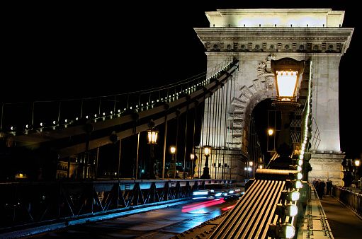 Picturesque view of ancient illuminated Chain Bridge over Danube river. Notable landmark of Budapest. Travel and tourism concept.