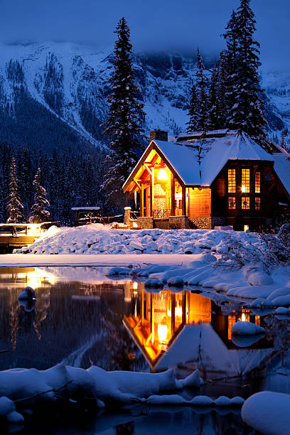 Wintery Cabin Reflection Wintery Cabin Reflection at Emerald Lake Lodge in Yoho National Park, British Columbia, Canada yoho national park photos stock pictures, royalty-free photos & images