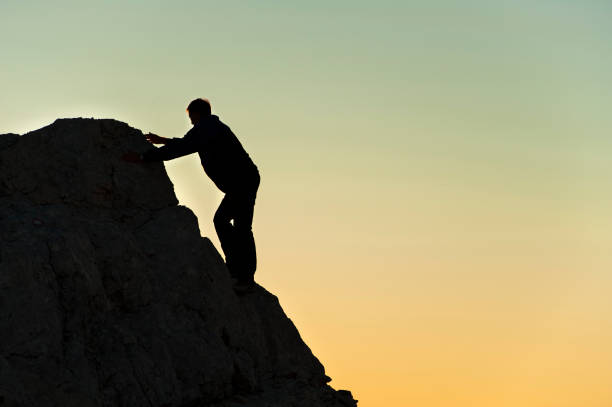 istock Mountain climber reaching the top 168267474