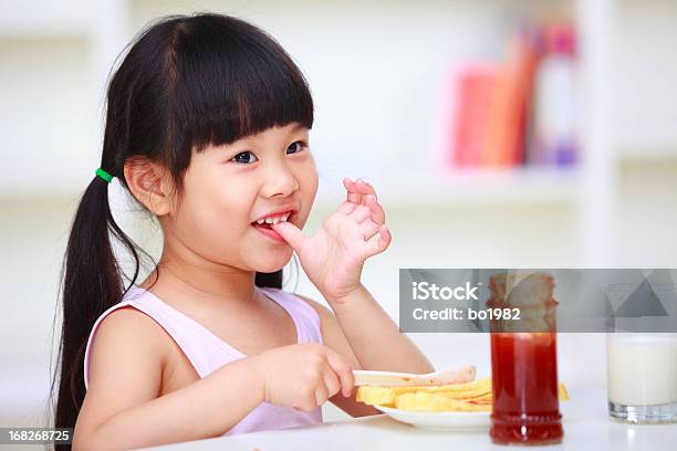 Lovely Little Girl Eating Bread Stock Photo - Download Image Now - 4-5  Years, Asian and Indian Ethnicities, Black Hair - iStock