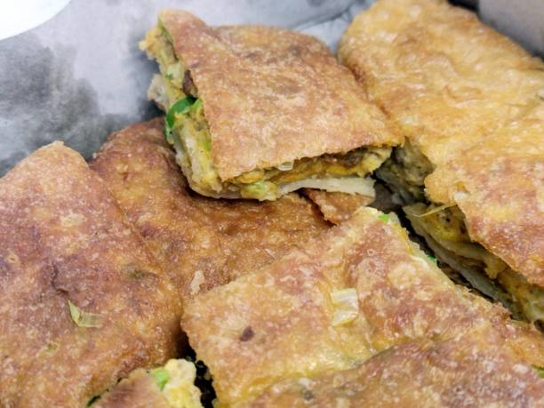 Martabak Telur Martabak Telur close up photo. One of Indonesian food. Savory pan-fried filled with eggs, spring onions and meat. gorengan stock pictures, royalty-free photos & images