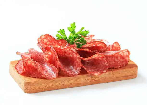 Slices of salami on a cutting board