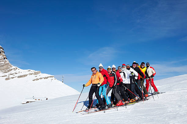 Happy skiing group Ski School. Group of people, skier. Snow skiing. Madonna di Campiglio .  Dolomiti di Brenta - Pietra grande , 2936m. The Brenta Group  is a Dolomite mountain range of the Southern Limestone Alps. ski instructor stock pictures, royalty-free photos & images