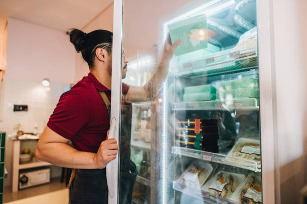 istock Business owner arranging refrigerator in a store 1682692919