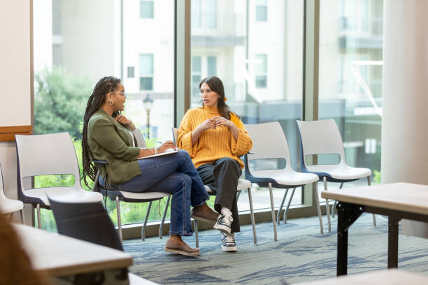 istock Female therapist meets female client in empty room at library 1682694557