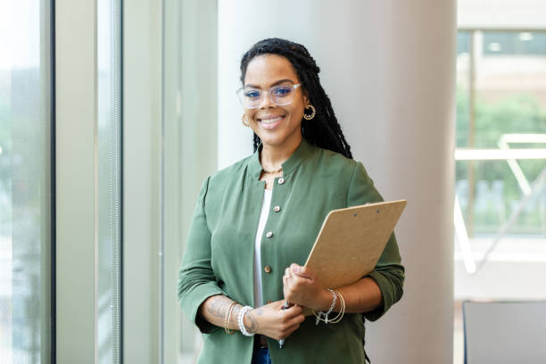 Successful female high school teacher poses for photo between classes