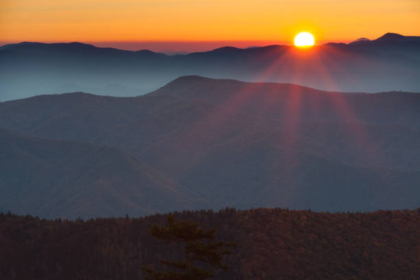 istock Sun setting behind the silhouette of mountains 168269534