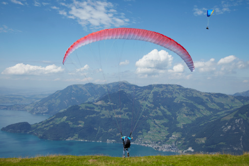A paraglider flying in a clear blue sky