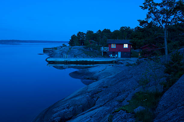 Red cottage in the archipelago just after sunset stock photo