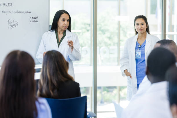 istock Serious female doctor points to unrecognizable medical student 1682710106
