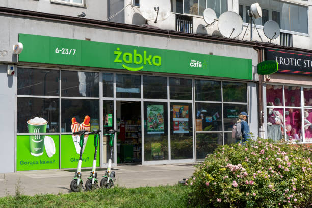 Polish grocery store sign ZABKA. Signboard supermarket. House building facade. Warsaw, Poland - July 26, 2023. stock photo