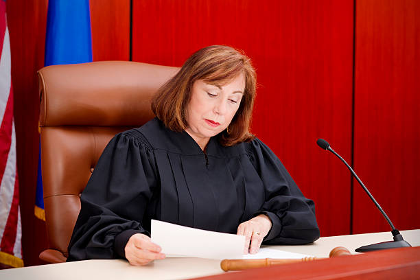 Senior female judge at the bench reading paper Senior female judge at the bench reading papers.  You might also be interested in this: judges stock pictures, royalty-free photos & images