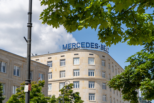 MERCEDES-BENZ logo on the building. Logotype automotive manufacturer Mercedes car brand sign on roof outdoors. Poland, Warsaw - July 27, 2023.