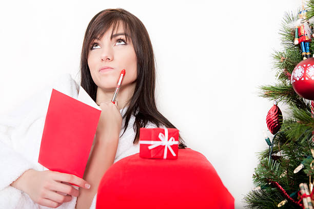 istock Young female writing christmas card 168271844