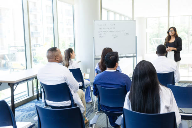 istock Female drug representative speaks to diverse unrecognizable doctors 1682722817