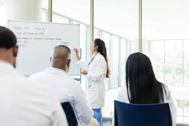 istock Female doctor talks with her peers about a difficult patient case that is coming up 1682723916
