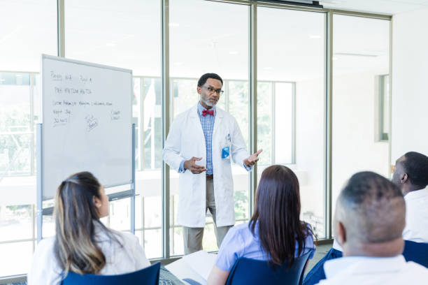 istock Mature male physician explains symptoms his patient has been having since starting an experimental medication 1682724468