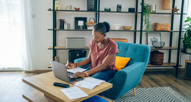 istock Young African woman doing her finances at home 1682729502