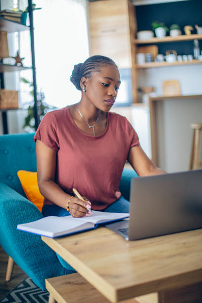 istock Young African woman doing her finances at home 1682730617