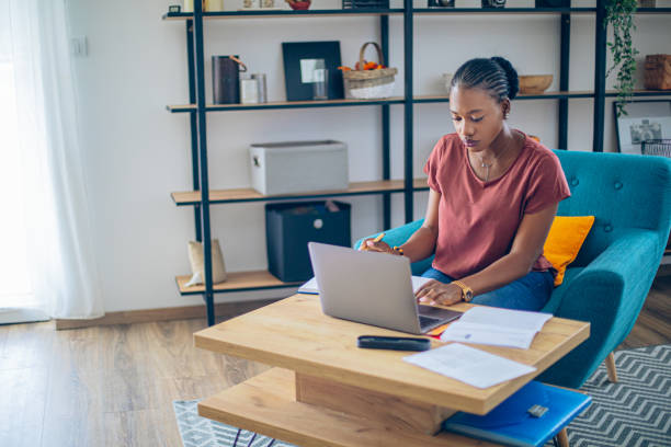 istock Young African woman doing her finances at home 1682733816